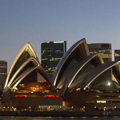 a train on a track in the city with Royal Ontario Museum in the background