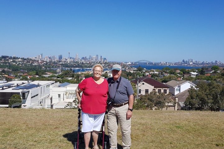 a man standing on top of a grass covered field