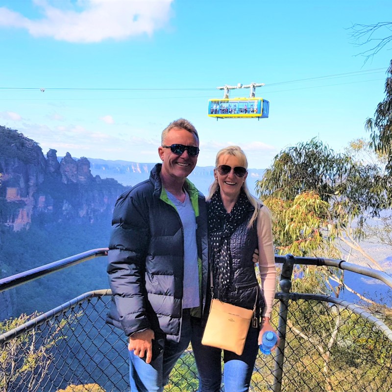a person holding a sign posing for the camera